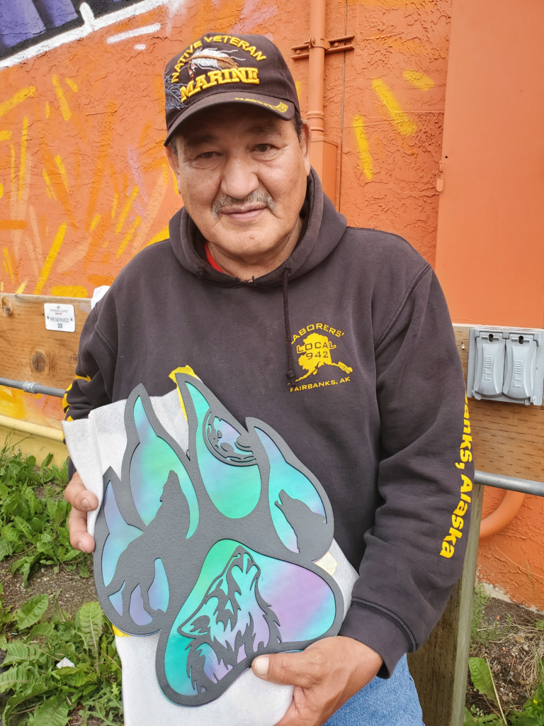 Alaska Native gentleman showing off his gift purchase.