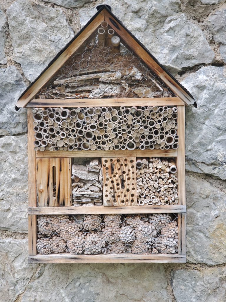 So-called "insect hotel" mounted on Casa de la Presa. These wooden structures are used all over Europe to encourage the survival of hibernating insects.