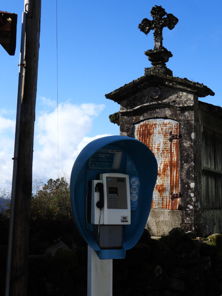 New and old: pay phone and ancient religious building