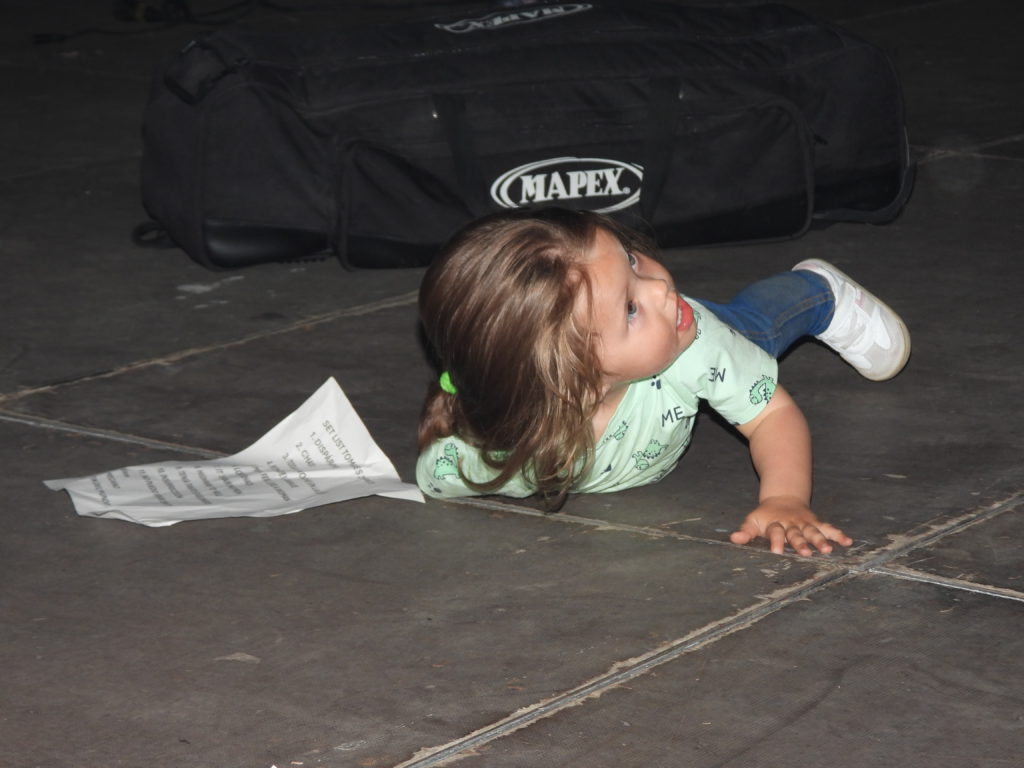 Tomorrow's rock star. That's the set list she's snuggling up to.