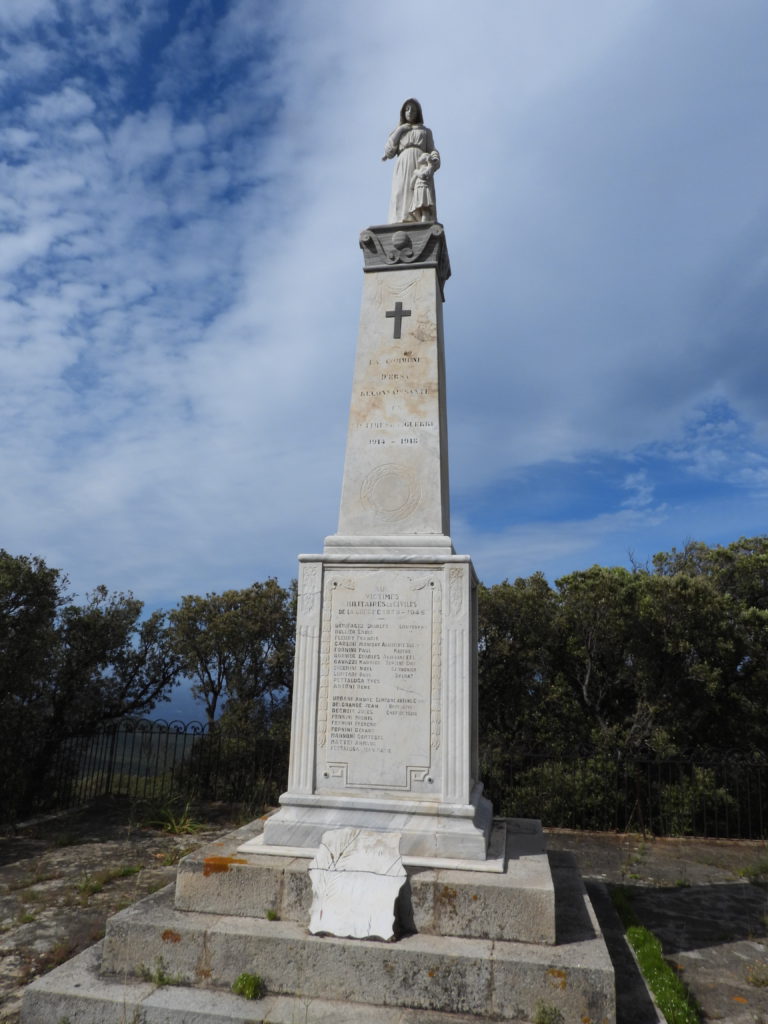 Monument to local WWI and WWII dead nestled next to the winding road.